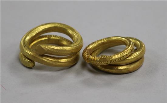 Two yellow metal spiral rings, one engraved and engraved torc-style ring, 49.5g gross